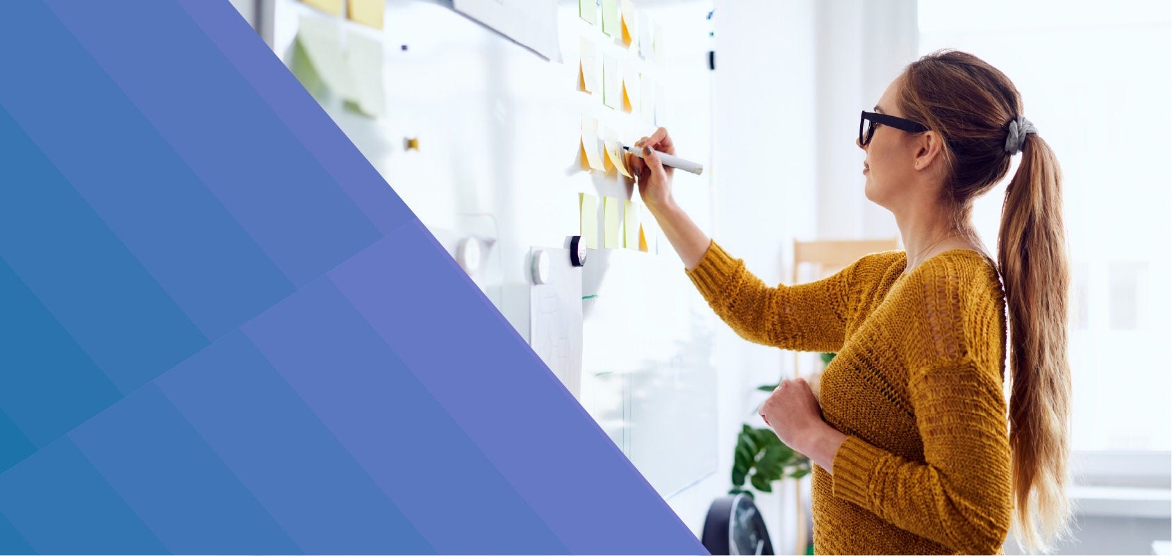Woman writing on a whiteboard during a brainstorming session