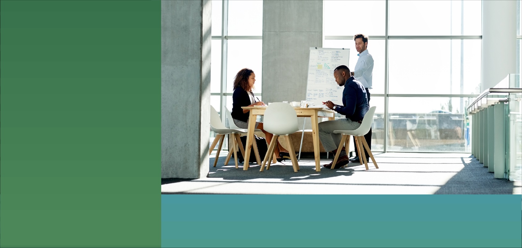 A small team discuss a project during a meeting in an open office environment.
