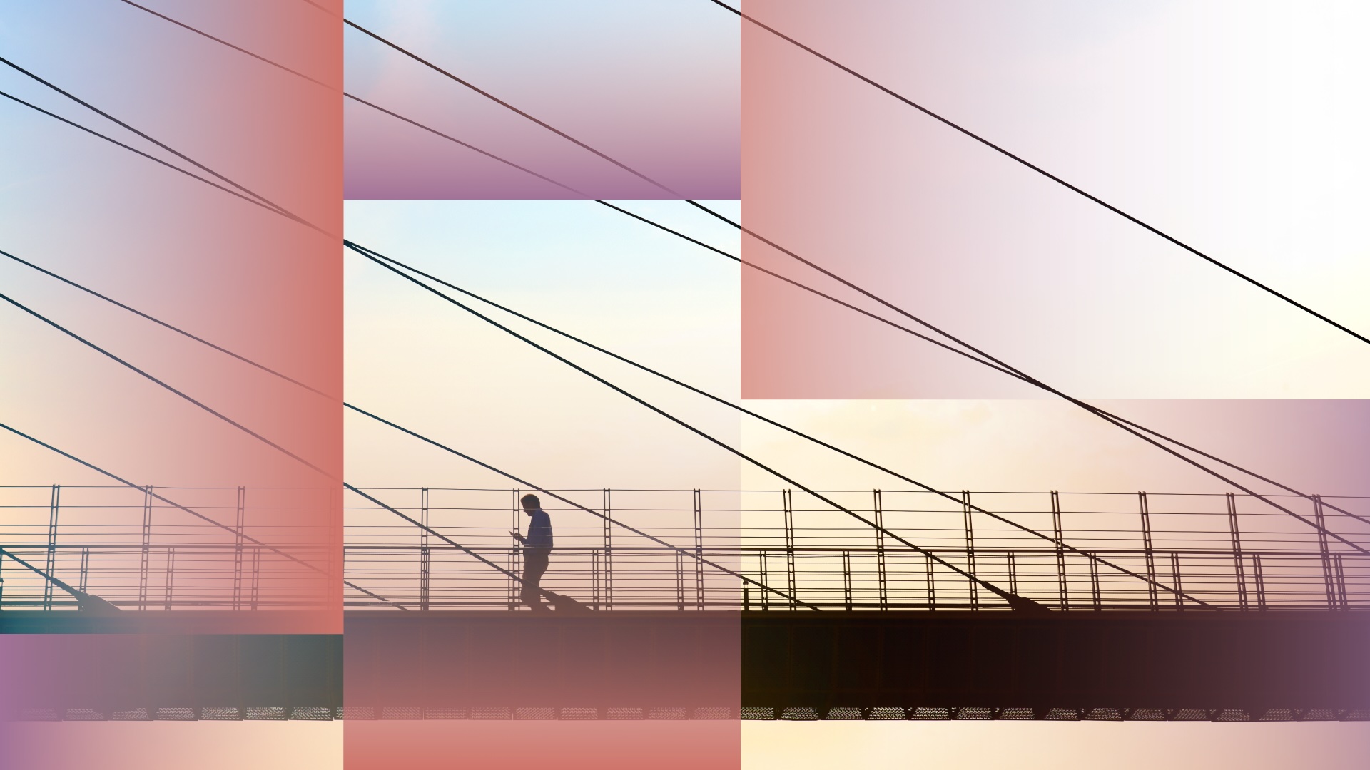 Man crossing a bridge while looking at his smartphone